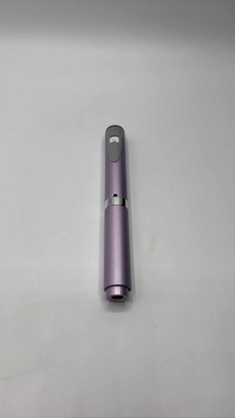 Generic reusable injection pen violet with cartridge, front view, compact and portable.