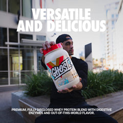Scoop pouring into glass, showcasing 26g protein per serving.