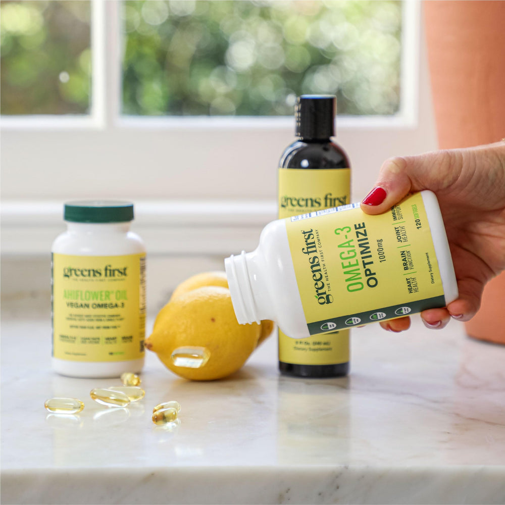 Greens First Omega-3 Optimize bottle on kitchen counter implies daily routine.