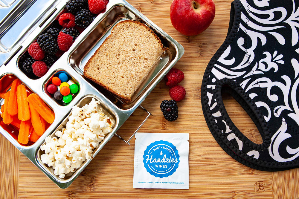 Handzies wipe used on hands showing gentle, residue-free cleansing.