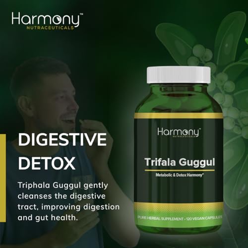 Person holding Harmony Nutraceuticals Trifala Guggul bottle for on‑the‑go use