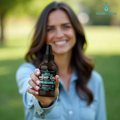 Healthergize hemp oil bottle closeup with golden, nutty oil.