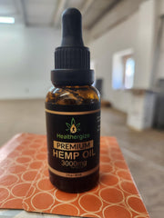 Healthergize Hemp Oil bottle on table highlights USA-made product.