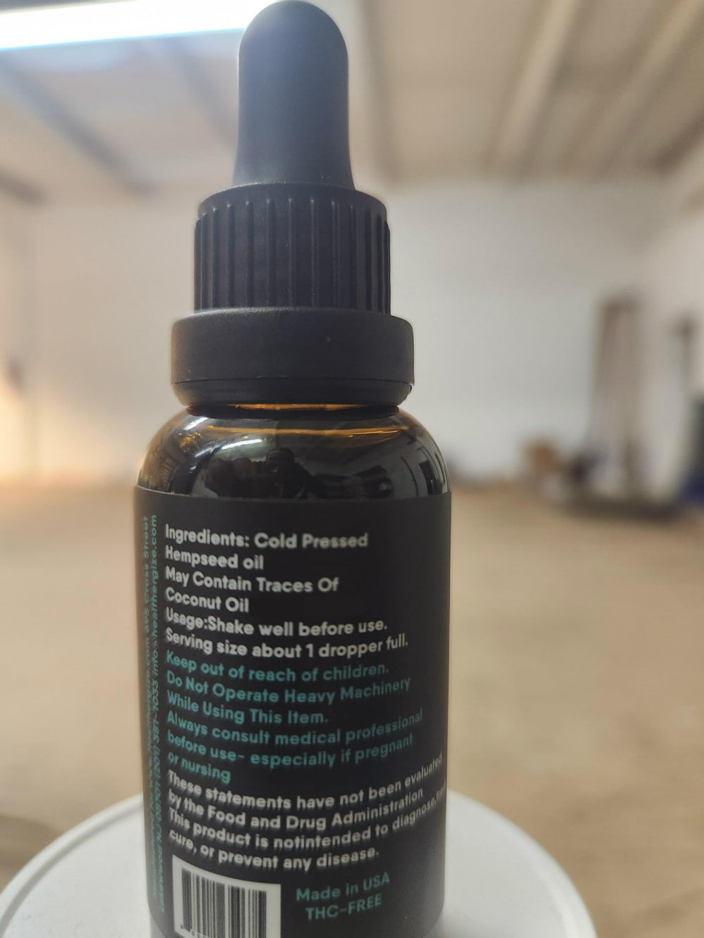 Healthergize hemp oil made in USA label on packaging.