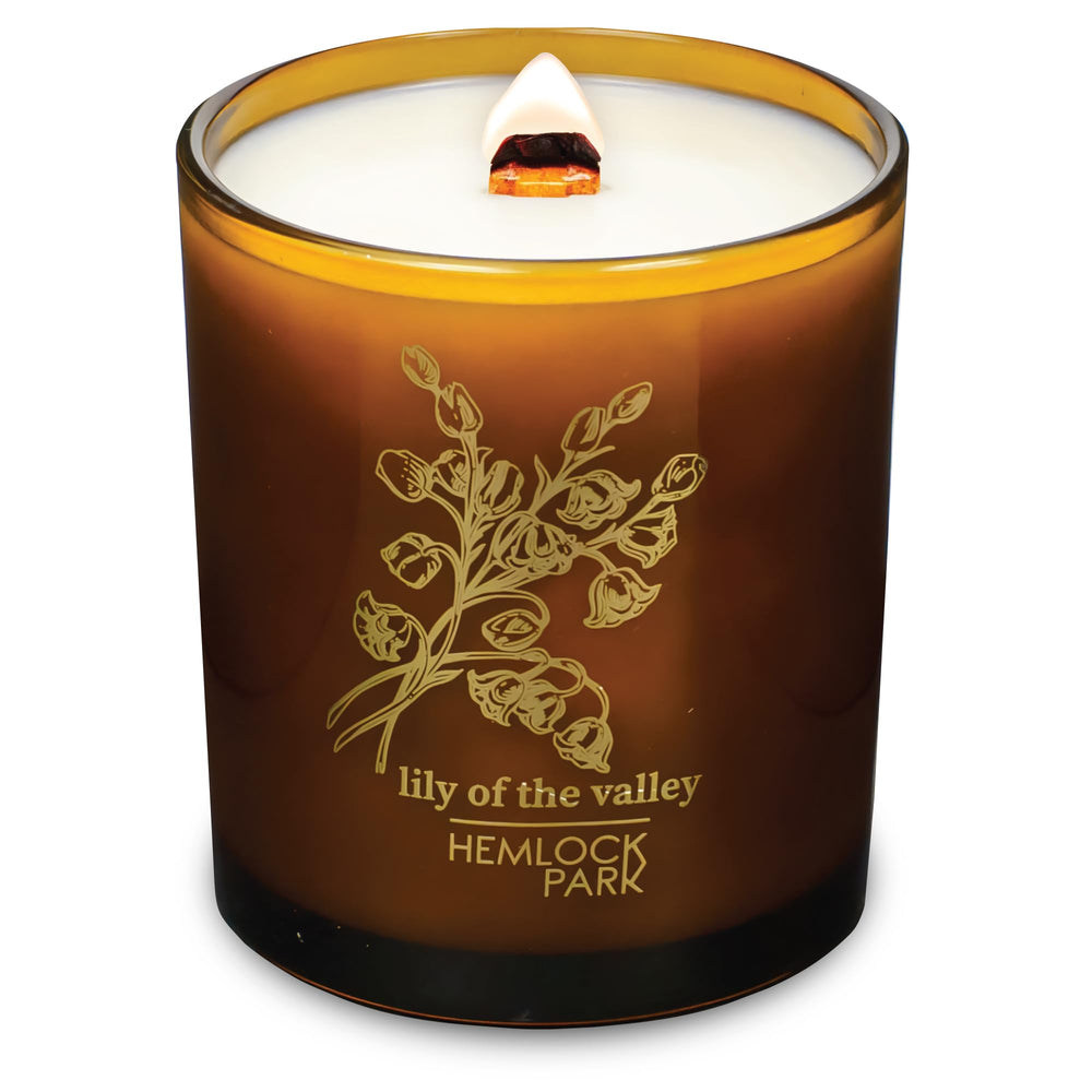 Hemlock Park Amber and Gold wood wick candle creates warm ambience with natural coconut wax, ideal for relaxation.
