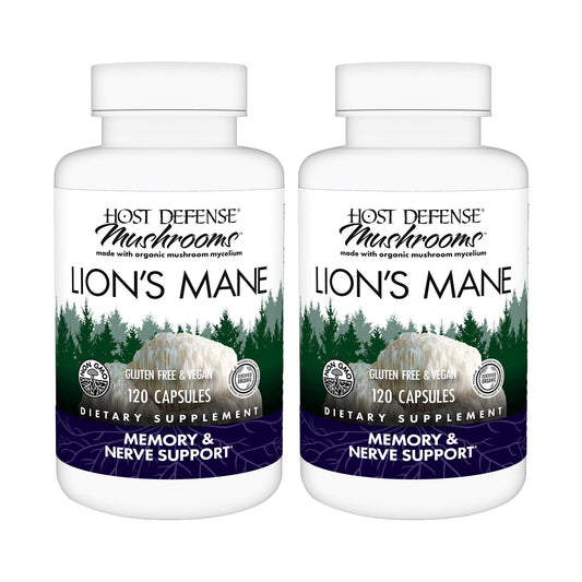 Host Defense Lion's Mane capsules bottle on wood for daily focus support.