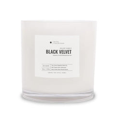 Hotel Collections Black Velvet Deluxe Candle jar glow enhances living room ambiance.