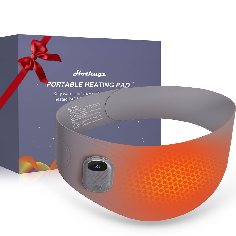 HOTHUGZ portable heating pad on waist for hands-free period relief during daily activities.