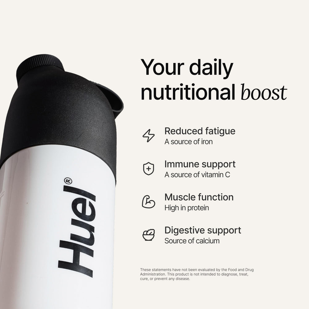 Huel shake in a glass after mixing, delivering smooth plant-based protein.