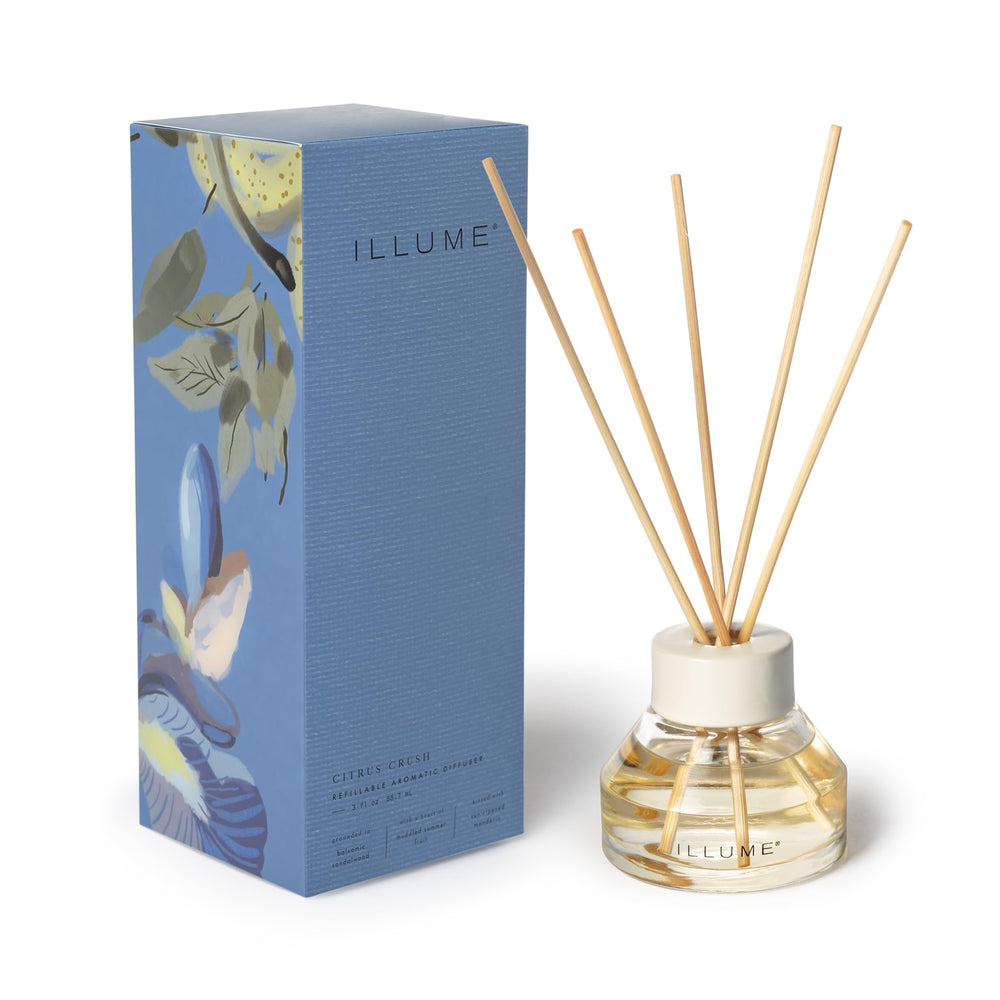 Illume Citrus Crush diffuser bottle releasing warm fragrance in living spaces.
