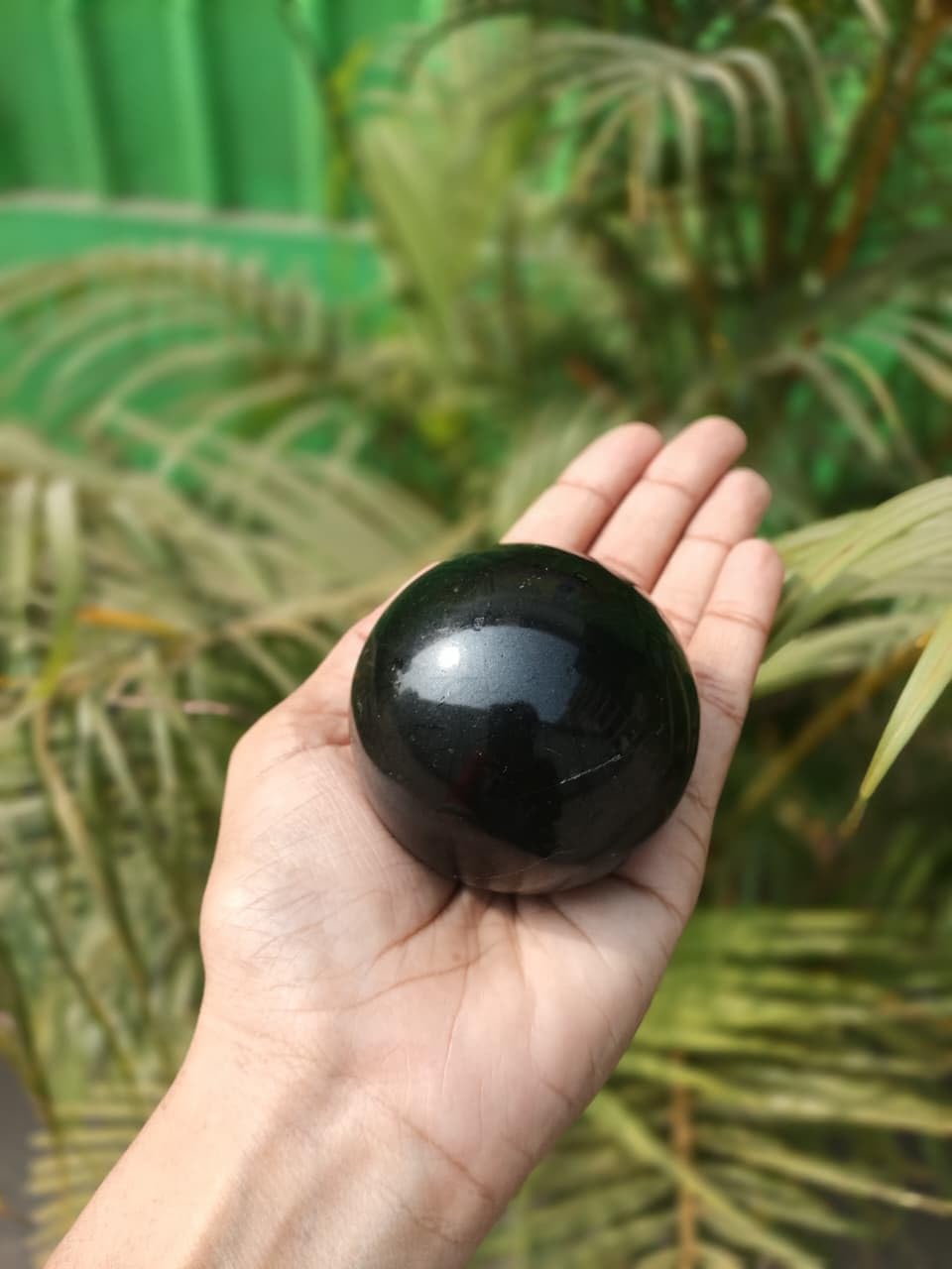 Jet International Jet Black Tourmaline Ball altar display for calm rituals and aura cleansing.