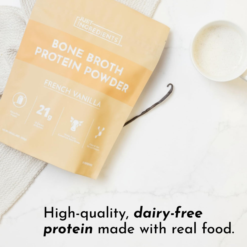 Just Ingredients bone broth protein powder vanilla scoop in mug, warm comforting drink.