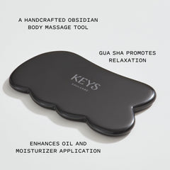 Keys Soulcare Obsidian Stone Gua Sha Tool closeup of the polished obsidian surface.