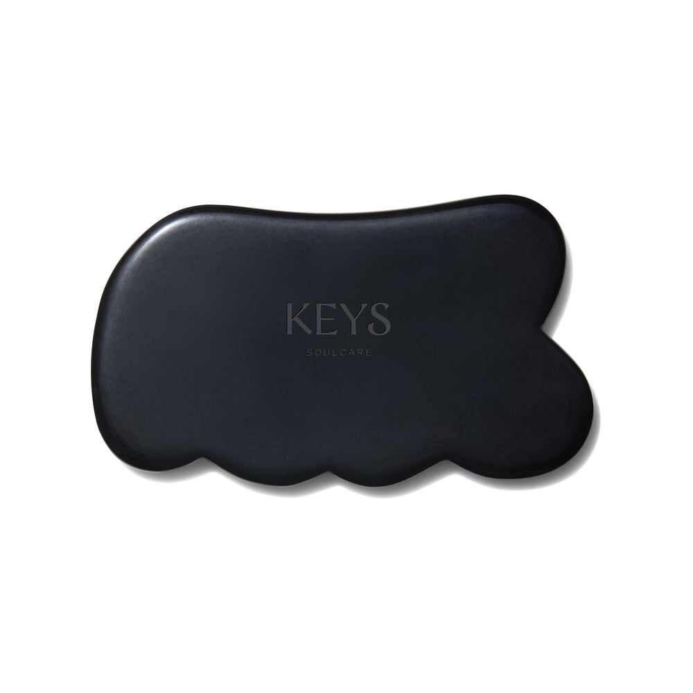 Keys Soulcare Obsidian Stone Gua Sha Tool front view for relaxing facial and body massage.