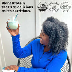 KOS protein powder scoop in glass shake illustrating convenient, quick nutrition.
