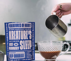 Kreatures of Habit Sleep chocolate cup on nightstand.