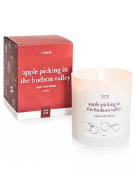 Literie NYC-inspired candle with apple-picking Hudson Valley scene for cozy ambience.