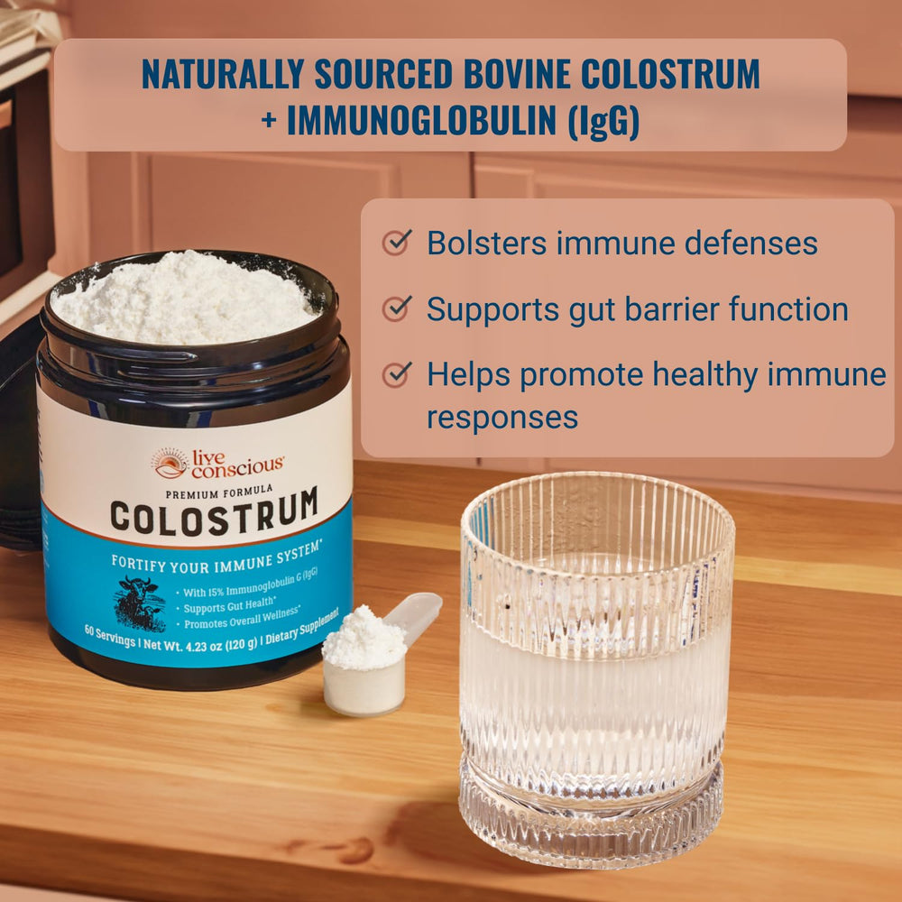 Live Conscious colostrum powder scoop beside bottle for convenient serving.