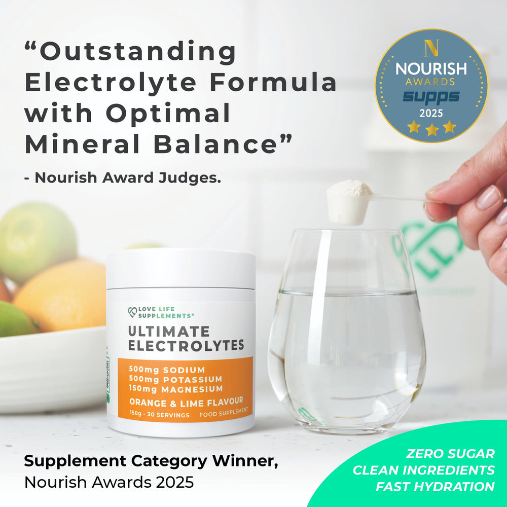 Love Life Electrolytes glass pour shows a refreshing orange-lime drink.