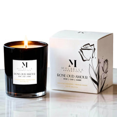 Malbella Essentials Rose Oud Amour candle in glass vessel creates elegant ambience.