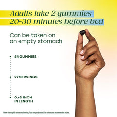 MegaFood Melatonin Gummies placed on a nightstand beside a glass of water.