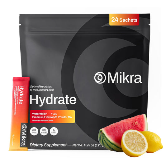 Mikra Hydrate Lemon Lime packet dissolving in a cup for quick hydration