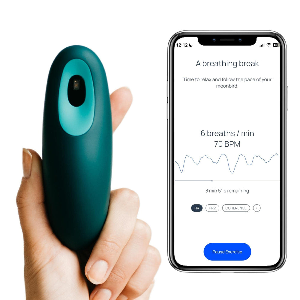 Moonbird breathing tool in blue-green held for calm breathing.