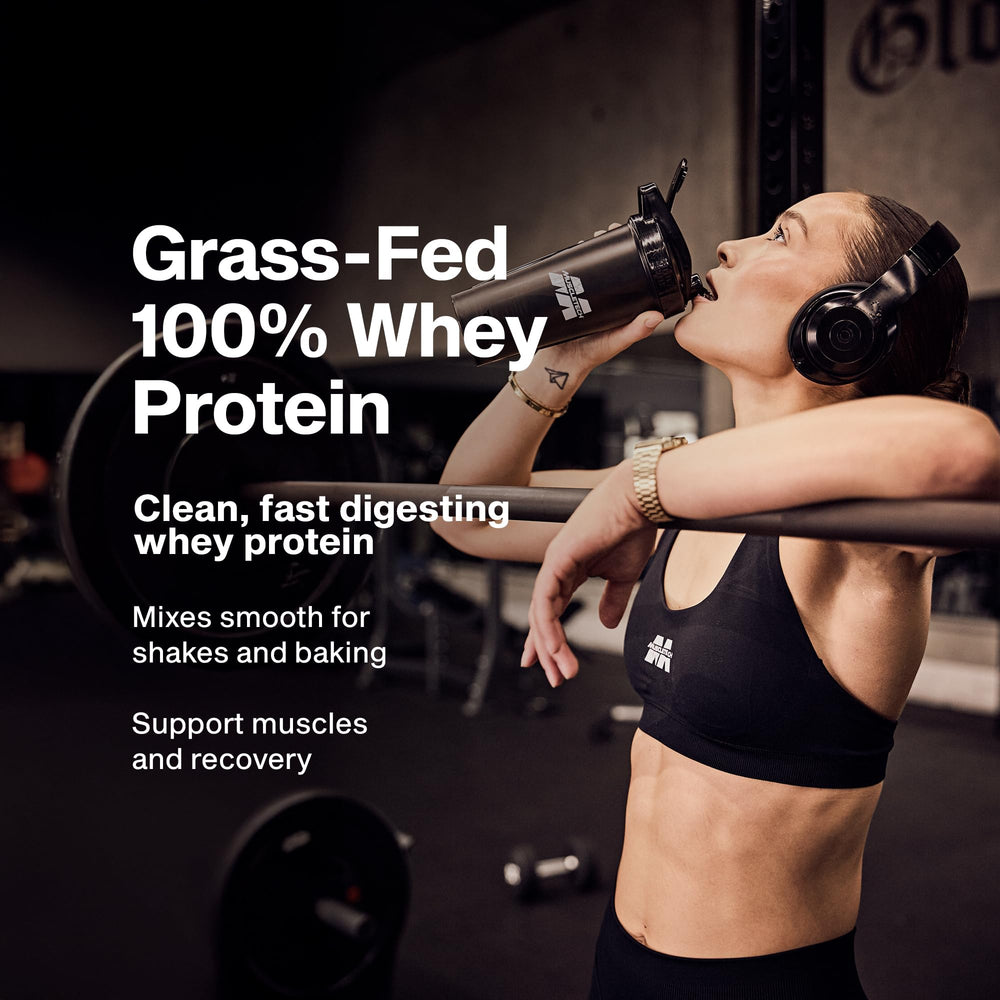 MuscleTech Grass-Fed Whey scoop beside tub highlighting easy mixing.