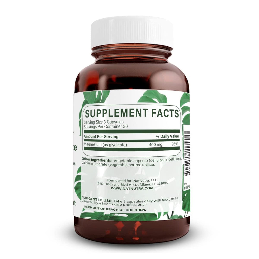 Close-up of Natural Nutra magnesium glycinate capsules ready for daily use