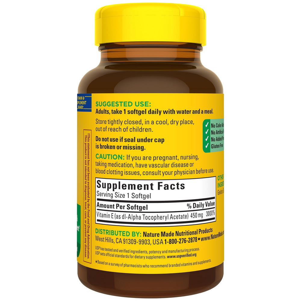 Golden Nature Made Vitamin E softgels inside bottle catching light