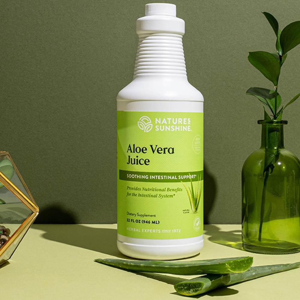 Pouring Nature's Sunshine Aloe Vera Juice into a glass for easy drinking