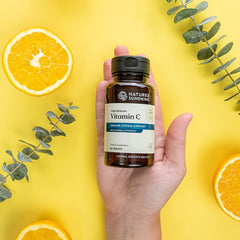 Close-up of Nature's Sunshine Vitamin C Time Release tablets showing time-release coating for steady intake.