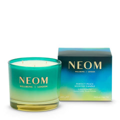 NEOM Perfect Peace candle lit with three wicks for calming ambiance