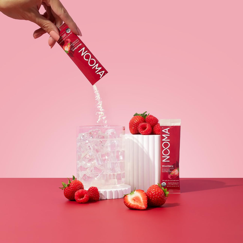 NOOMA electrolyte mix being poured into a glass for fast hydration