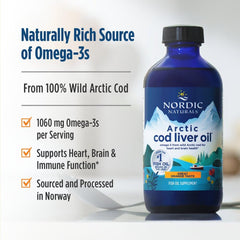 Nordic Naturals Arctic Cod Liver Oil orange bottle on kitchen counter—quick daily omega-3 supplement.