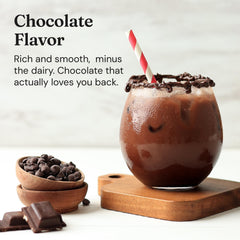 Cup with frothy FloFit shake alongside a snack for healthy balance