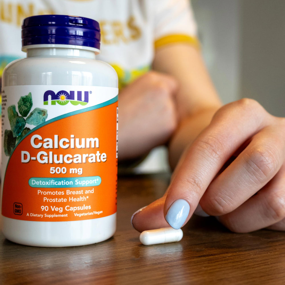 NOW Foods Calcium D-Glucarate capsules being poured into cap.