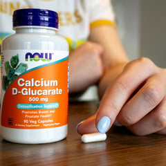 NOW Foods Calcium D-Glucarate capsules being poured into cap.