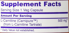 NOW Foods L-Carnitine 500 mg bottle beside gym gear suggesting fitness use.