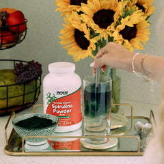NOW Foods Spirulina powder in bowl with smoothie, vibrant green color