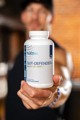 NuEthix Gut Defender+ bottle in use suggests daily wellness routine.