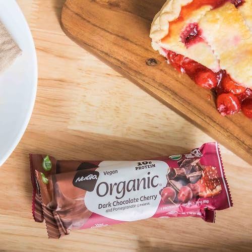 Close-up of NuGo bar reveals rich dark chocolate coating, ideal for vegan snacking.