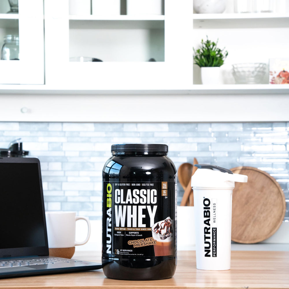 NutraBio Classic Whey chocolate milkshake in a glass, creamy texture.