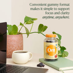 OM Lion’s Mane Gummies displayed with fresh strawberries for flavor cue.