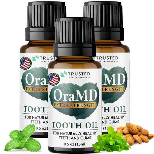 OraMD 4-in-1 Extra Strength Tooth Oil bottle with pour promotes gum health.