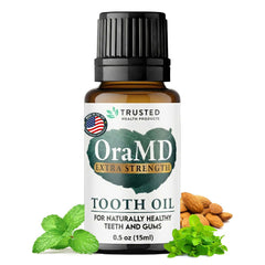 OraMD 4-in-1 tooth oil bottle on counter showing natural, multi-use care.