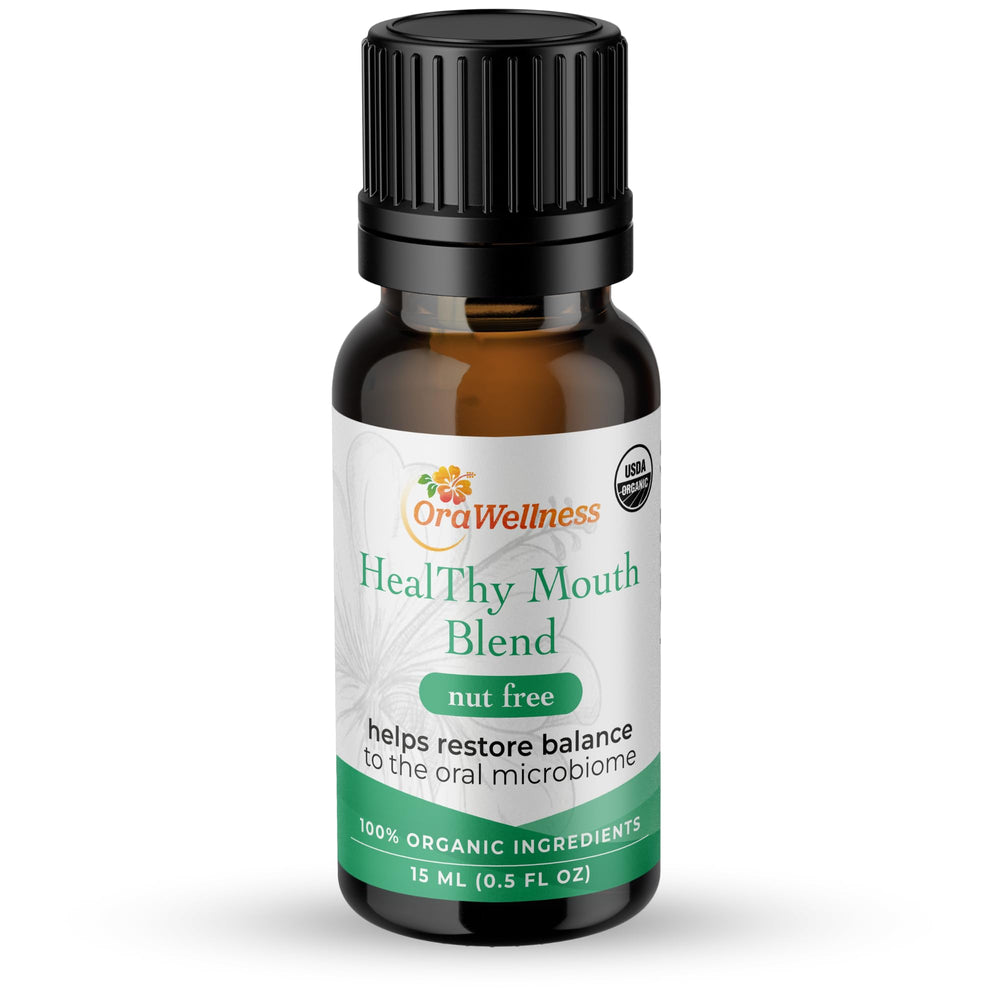 OraWellness Nut Free Healthy Mouth Blend drops on a toothbrush for easy brushing.