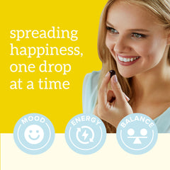 Organifi Happy Drops packaging shown beside a notebook for a mindful routine