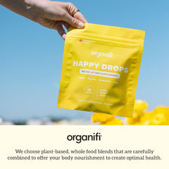 Glass of water with Happy Drops gummies for easy daily use