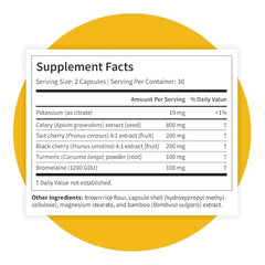 Pattern Wellness Uric Acid Support bottle beside a glass of water.